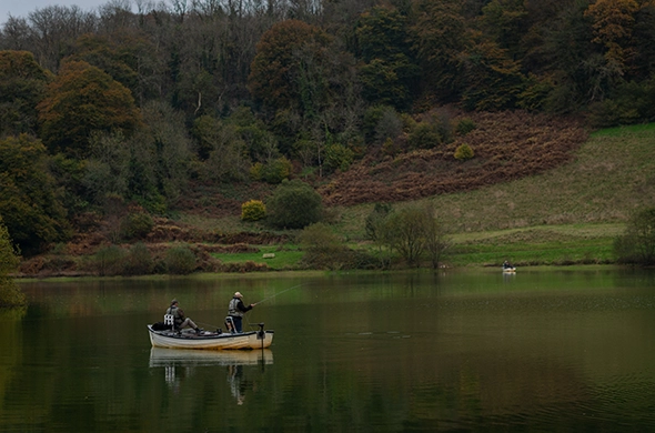 People fishing on a boat on Clatworthy Reservoir