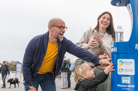 Family filling up a water bottle at a Wessex Water refill point