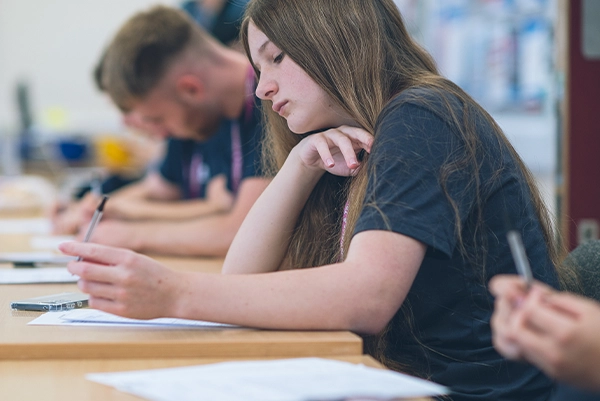 Female Apprentice Sat At A Desk